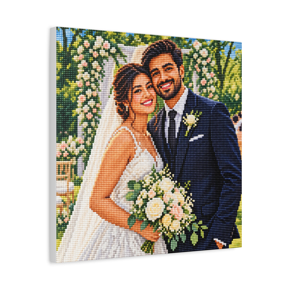 A square canvas print featuring a pixelated, mosaic-style portrait of a smiling bride and groom outdoors. The bride wears a white wedding dress and veil and holds a bouquet of white and pink flowers, while the groom wears a dark navy suit with a white boutonniere.