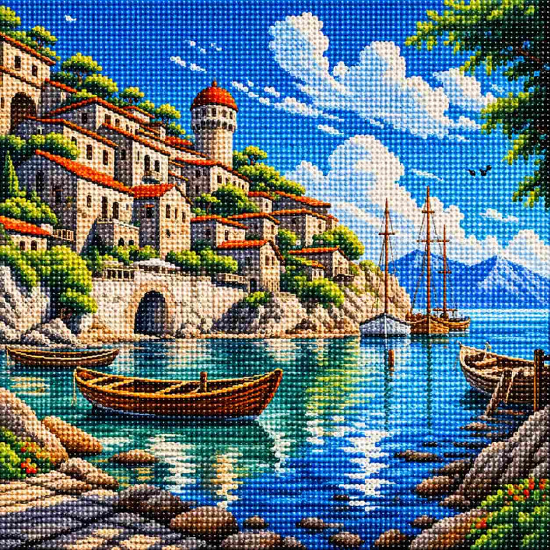 Full diamond painting of a Mediterranean coastal village with stone houses, boats, turquoise sea, mountains, and blue sky made with sparkling resin diamonds