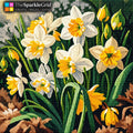 TheSparkleGrid daffodil diamond painting featuring sparkling white and yellow flowers with green leaves, created with colorful resin diamond drills.