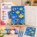 TheSparkleGrid Kids Paint By Numbers Kit featuring a colorful underwater fish painting with coral, shells, bubbles, numbered canvas, acrylic paints, brushes, reference card, and branded packaging.