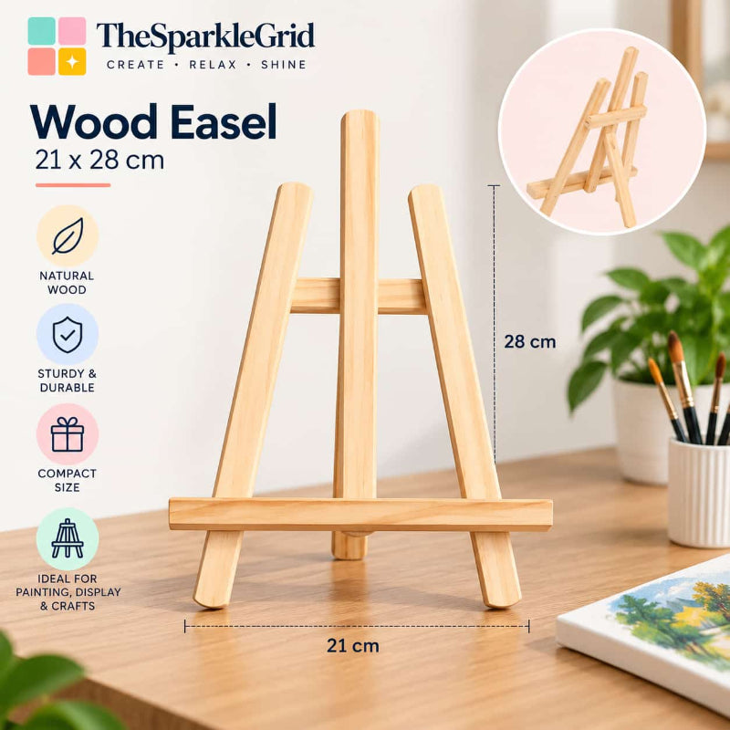 A small wooden easel shown on a tabletop in a styled indoor setting, with measurement callouts indicating 21 cm width and 28 cm height. The image includes TheSparkleGrid branding, feature icons for natural wood, sturdy construction, compact size, and suitability for painting and crafts, plus a circular inset showing the easel from the back.